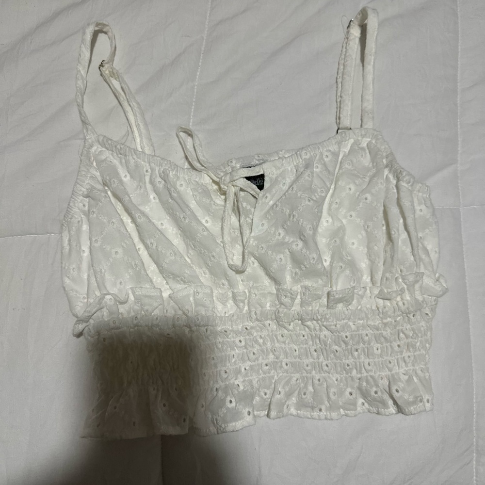white tank, ruffled at bottom, stretched at bottom and patterned